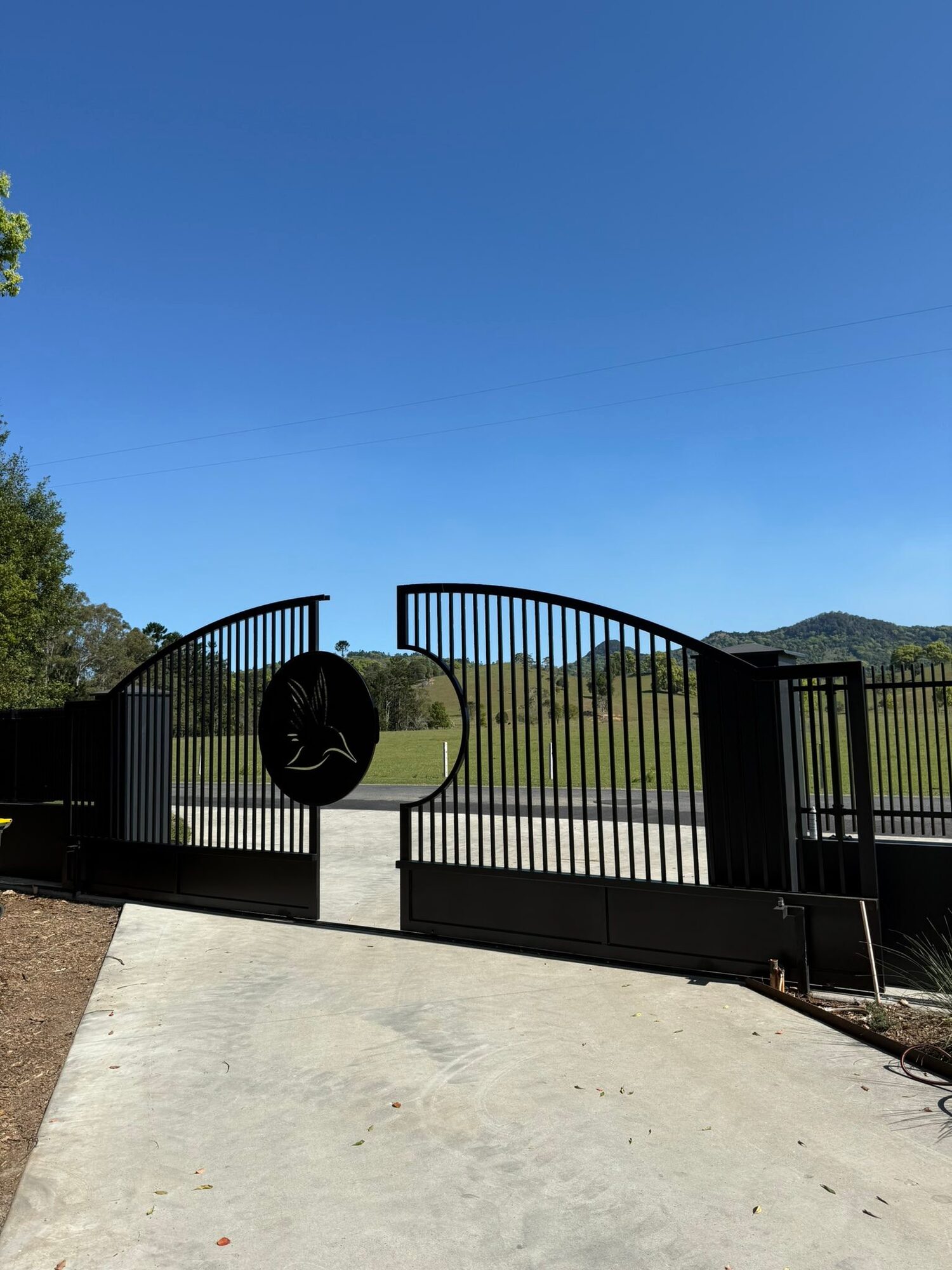 Entrance gates and rendered pillars at a rural property