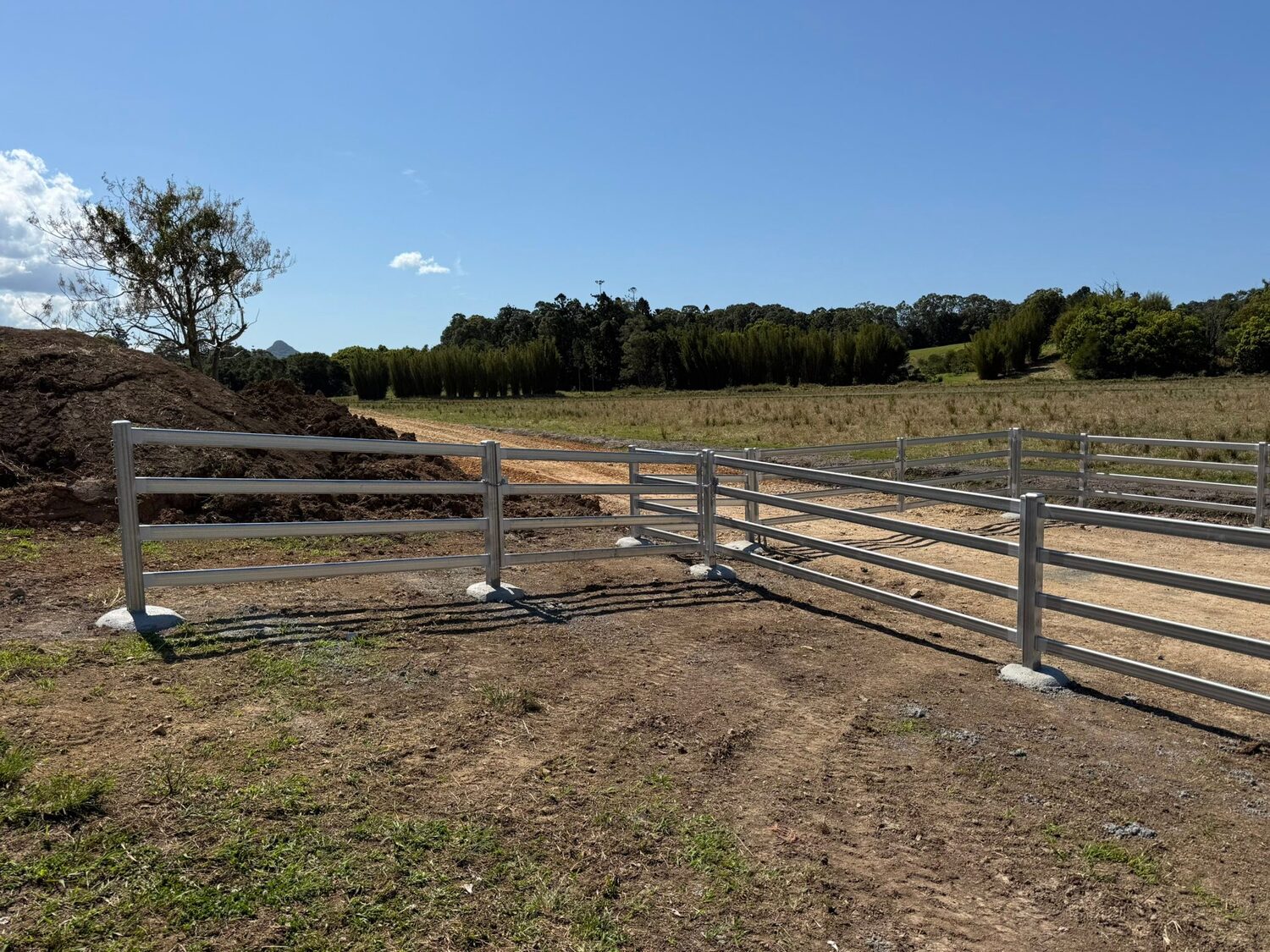 Cattle rail laneway leading to a farm track